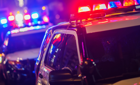 A police vehicle with the lights on.