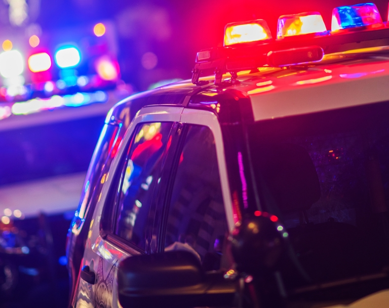 A police vehicle with the lights on.