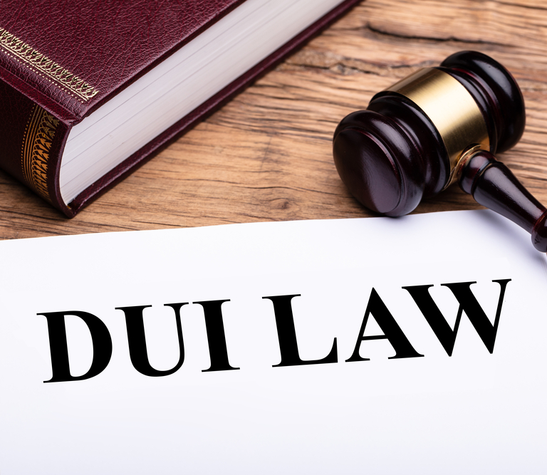 DUI Law written across a paper sitting next to a book and gavel.