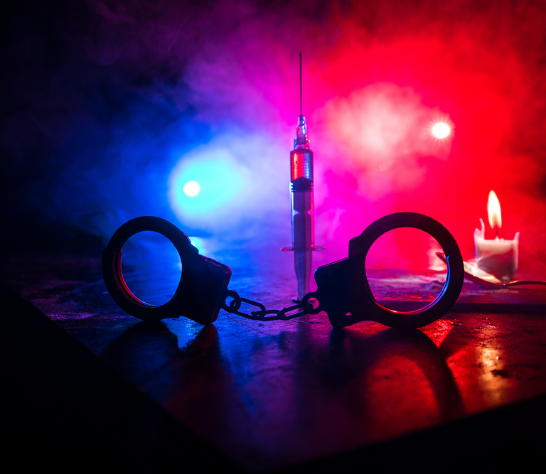 Handcuffs in police lights.