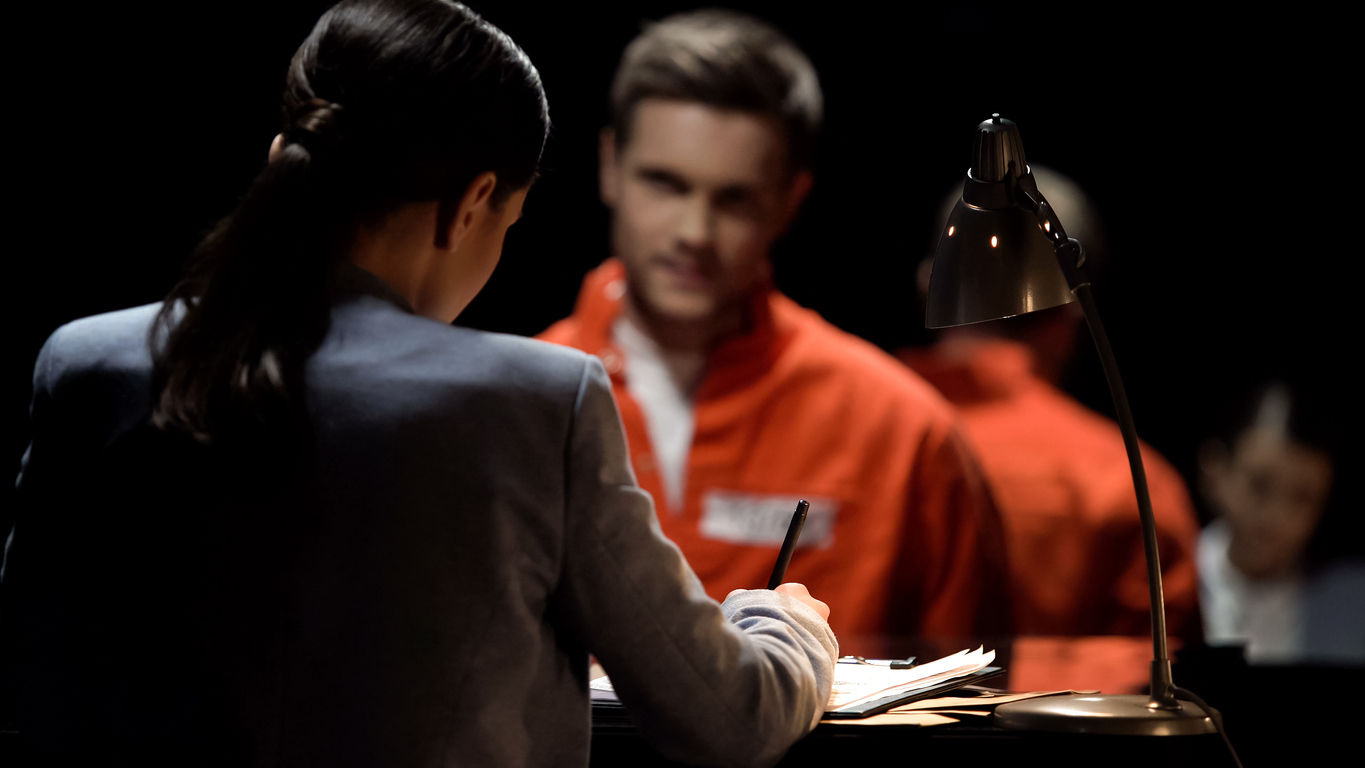 Male criminal wearing orange prison jumpsuit talking to a female lawyer in dim lit room. When you’re ready to appeal your criminal case, our criminal appellate lawyers can help. 