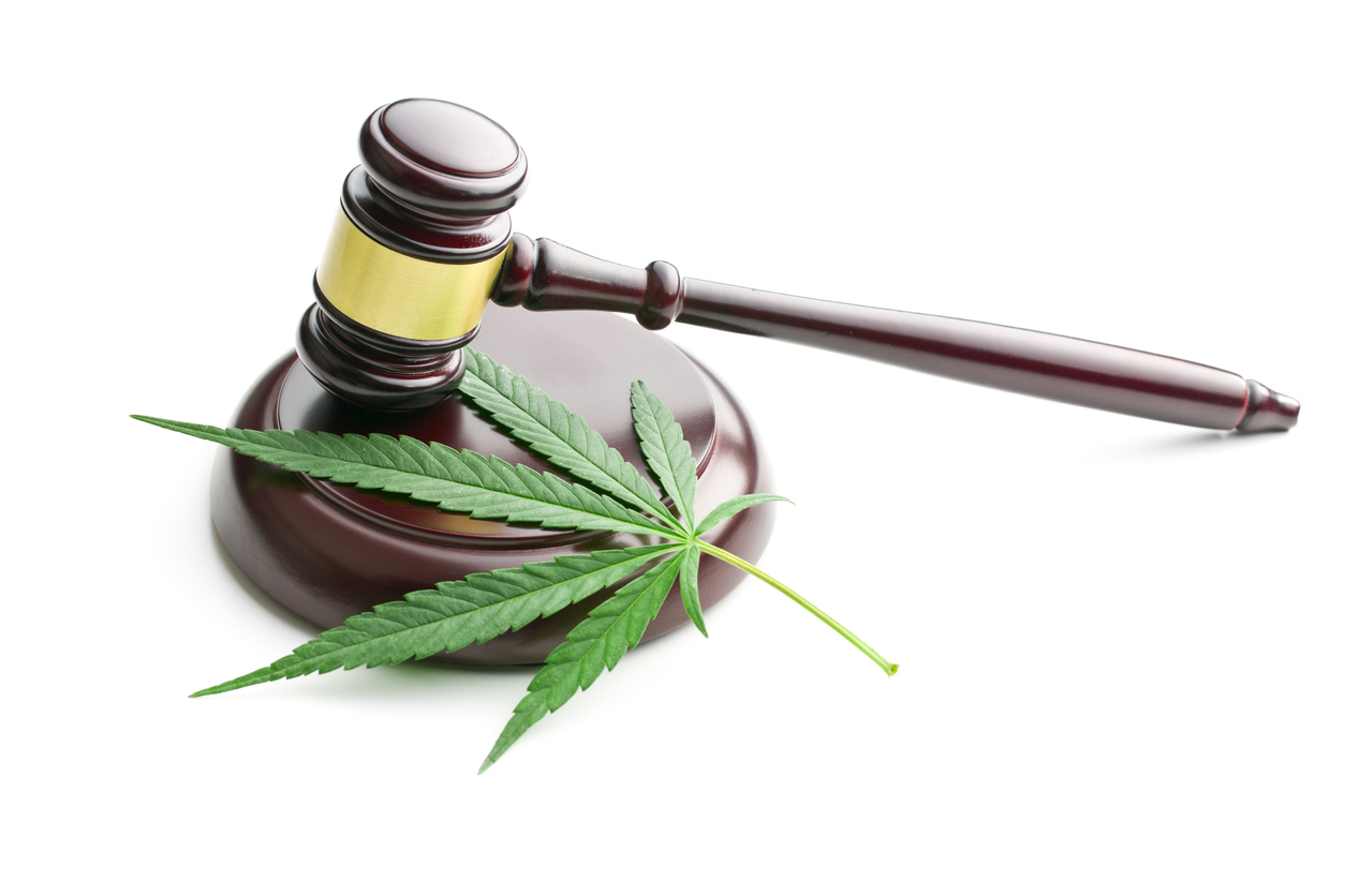 Cannabis leaf and judge gavel. If you've been charged with a marijuana crime in Kansas, contact the marijuana crime lawyers at Henderson Legal Defense, LLC today.